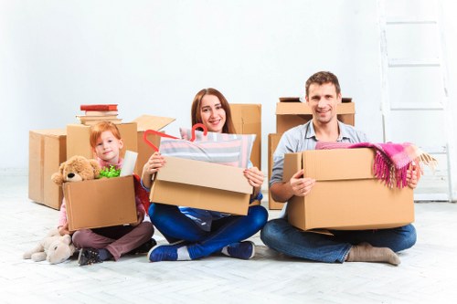 Boxes and furniture being moved from a flat with stair access